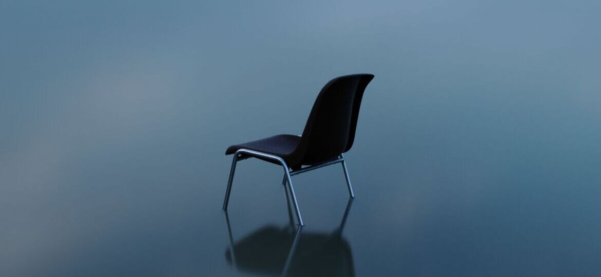 Single chair reflecting on a water surface on a stormy day