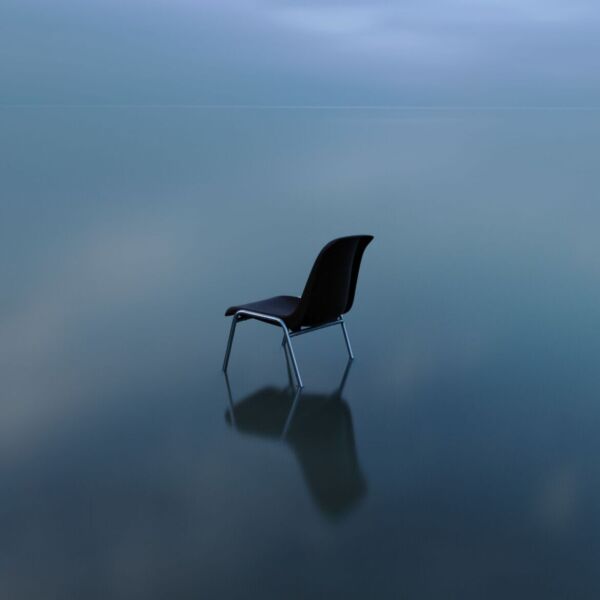 Single chair reflecting on a water surface on a stormy day